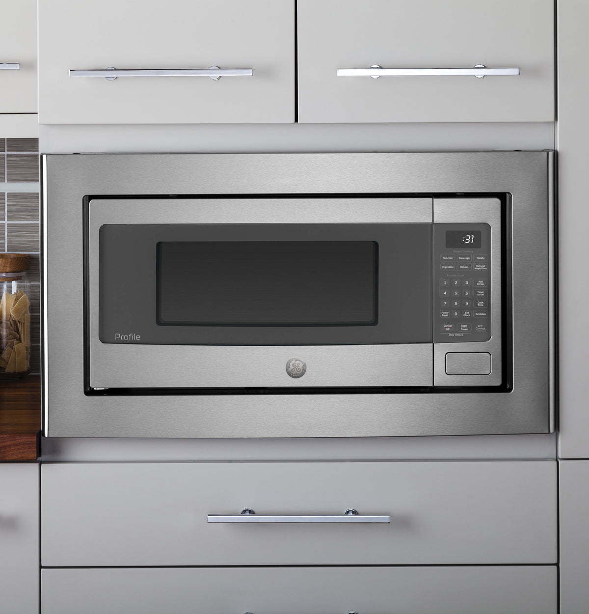 27-inch stainless steel built-in trim kit around microwave in modern kitchen appliances and home improvement setting
