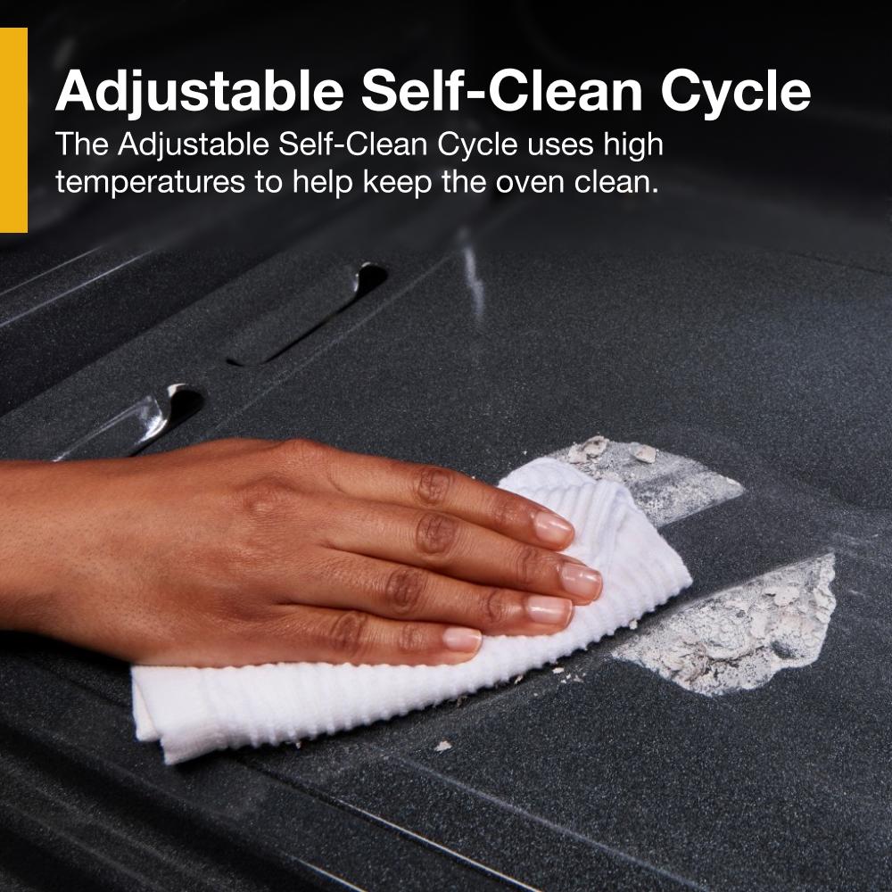 Hand wiping oven interior surface with white cloth highlighting adjustable self-clean cycle feature from Kitchen & Kitchenware collection