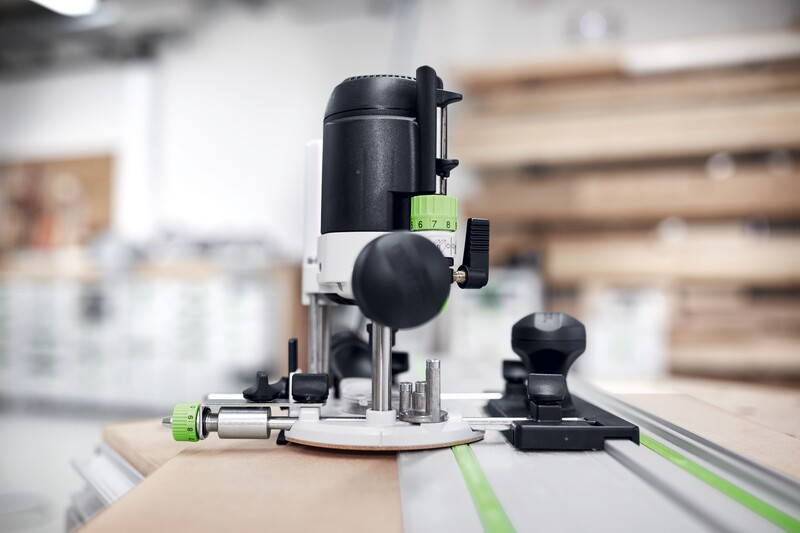Woodworking router with fine adjustment guide stop and green numbered dial for precise tool control in home improvement