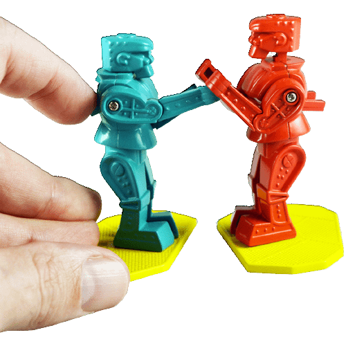 Hand holding teal miniature boxing robot facing red robot on yellow bases from Toys & Games collection under $50