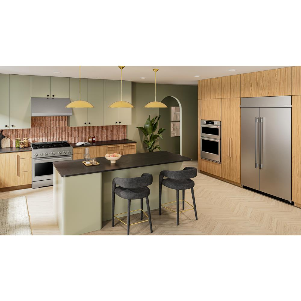 Modern kitchen interior featuring stainless steel appliances, wood cabinetry, and black countertop island with seating