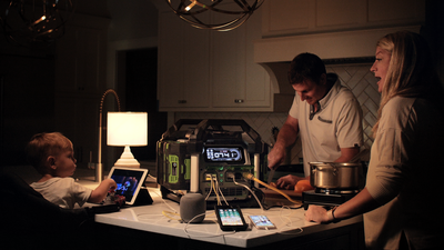 Family using EGO portable power station with dual 7.5Ah batteries charging devices during indoor home improvement task