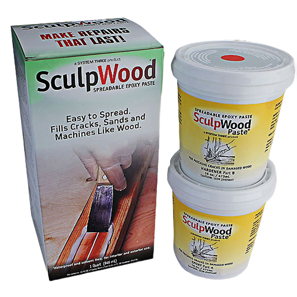 Two yellow tubs of spreadable epoxy paste stacked beside a labeled box for home improvement and wood repair use