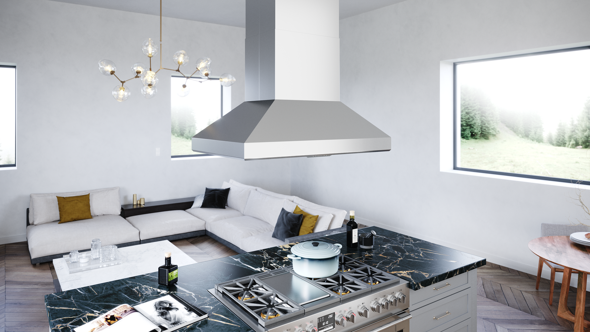 Stainless steel island range hood with a tapered canopy suspended above a large professional gas cooktop in a bright kitchen with marble countertops, part of Over the Range Hoods, Island Range Hoods, and Kitchen & Kitchenware collections.