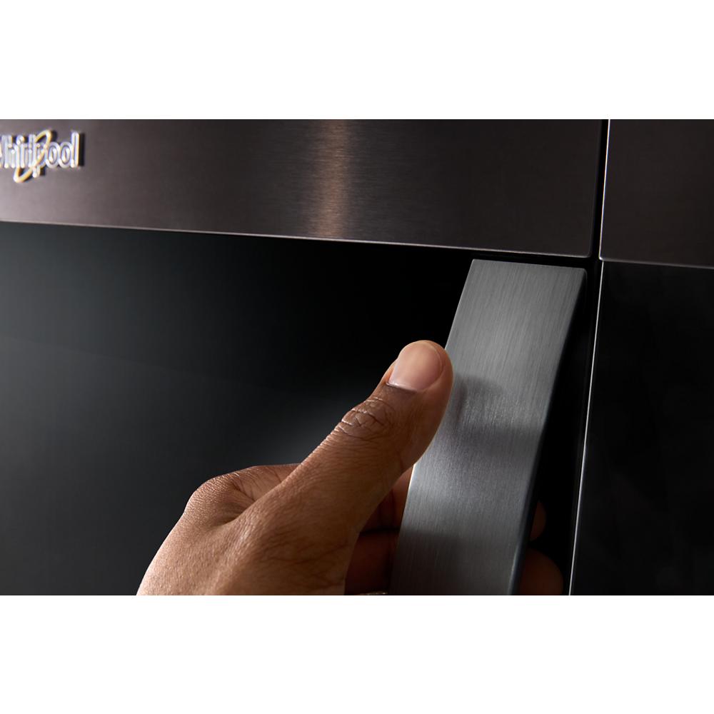 Close-up of hand gripping the handle on black stainless steel over the range microwave from kitchen appliances collection