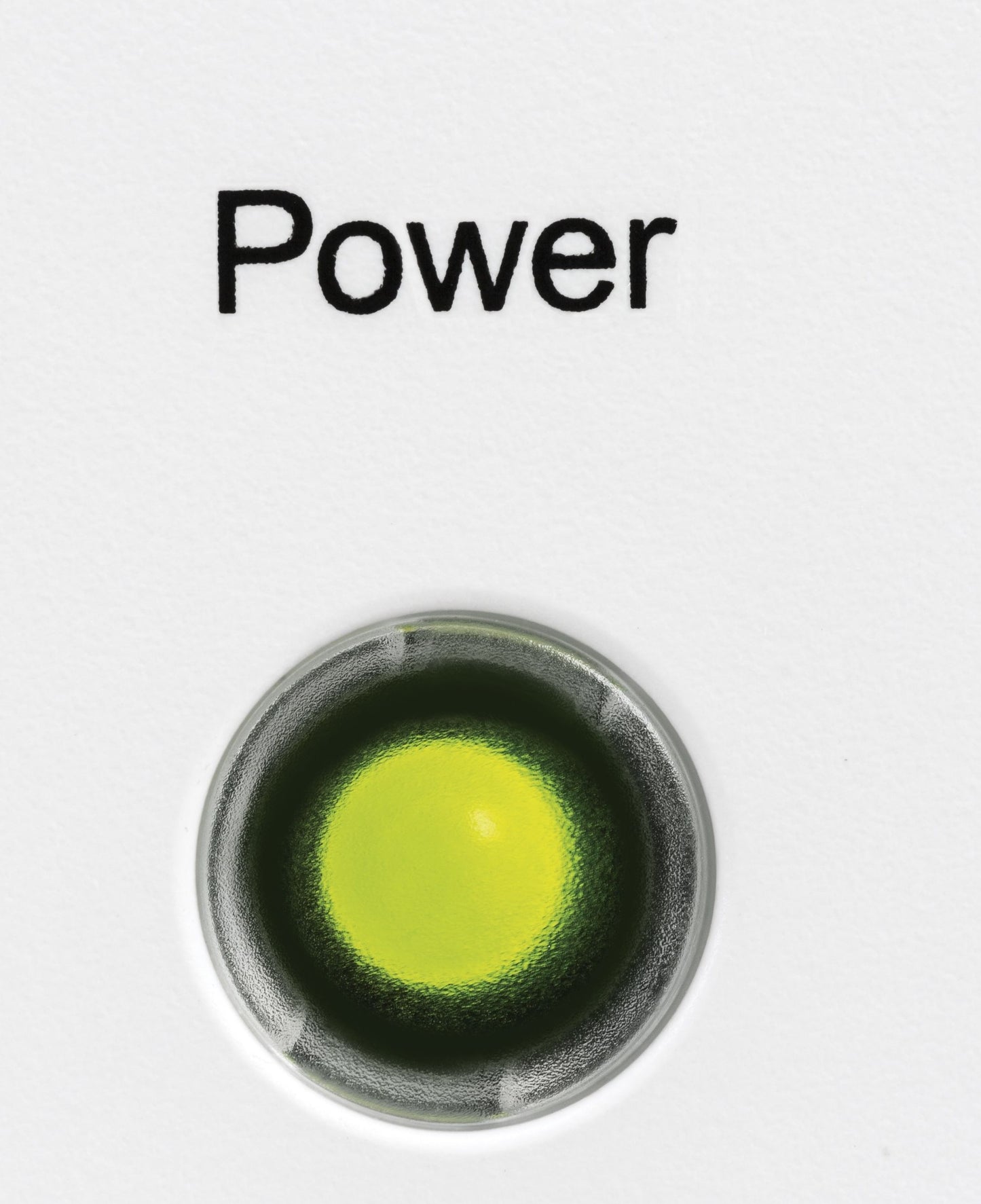 Close-up of green power indicator light on white appliance surface in home improvement freezer category