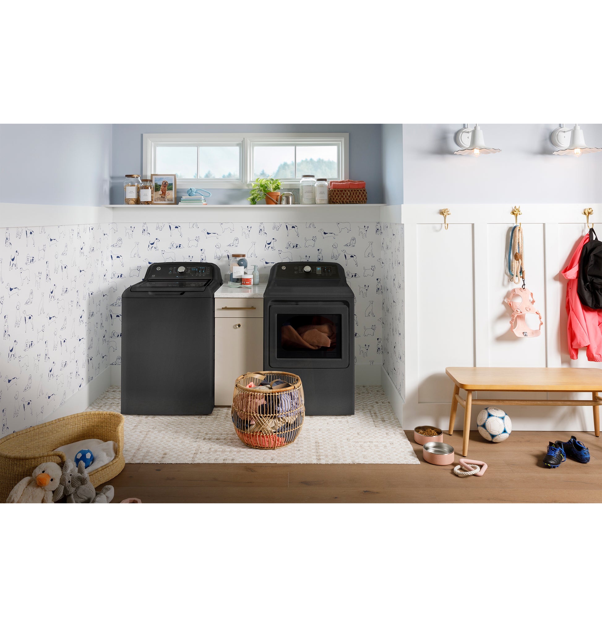Matte black top load washer and matching dryer in bright laundry room with kids’ toys and bench, Washers & Dryers collection