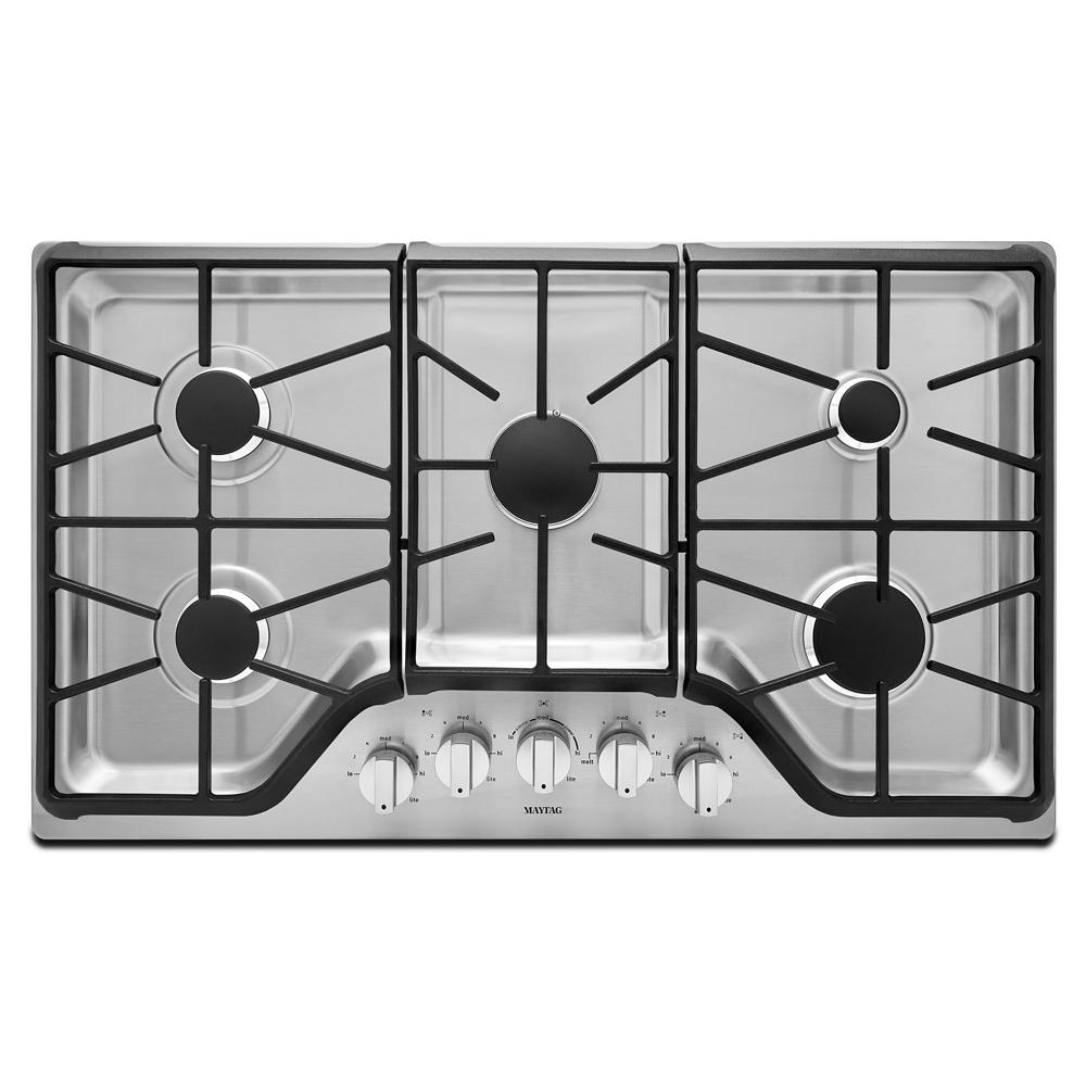 Large stainless steel gas cooktop with five burners and black cast iron grates for home improvement kitchens
