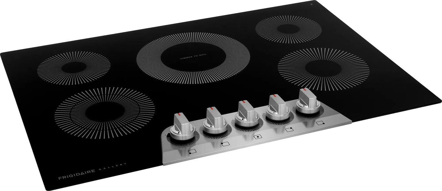 Black electric cooktop with five circular heating elements and silver control knobs in kitchen appliances collection