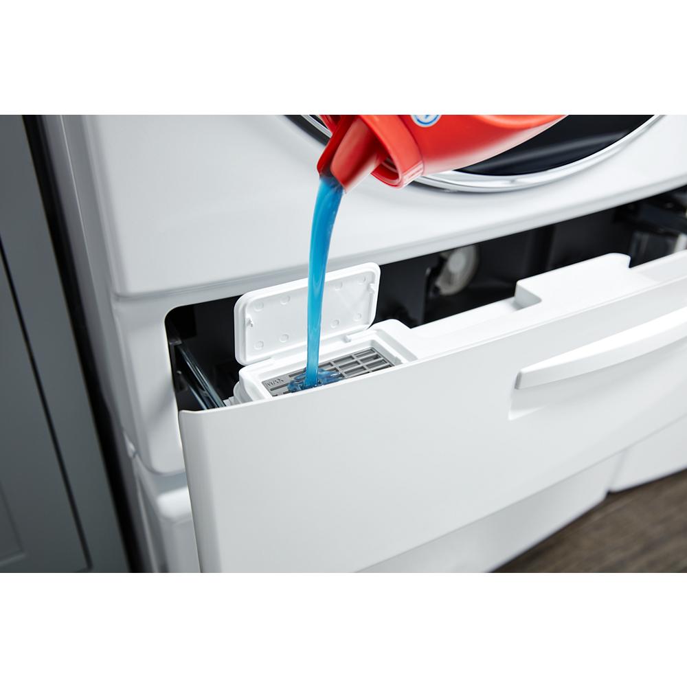 Liquid detergent being poured into the Load & Go XL dispenser compartment of a front load washer drawer