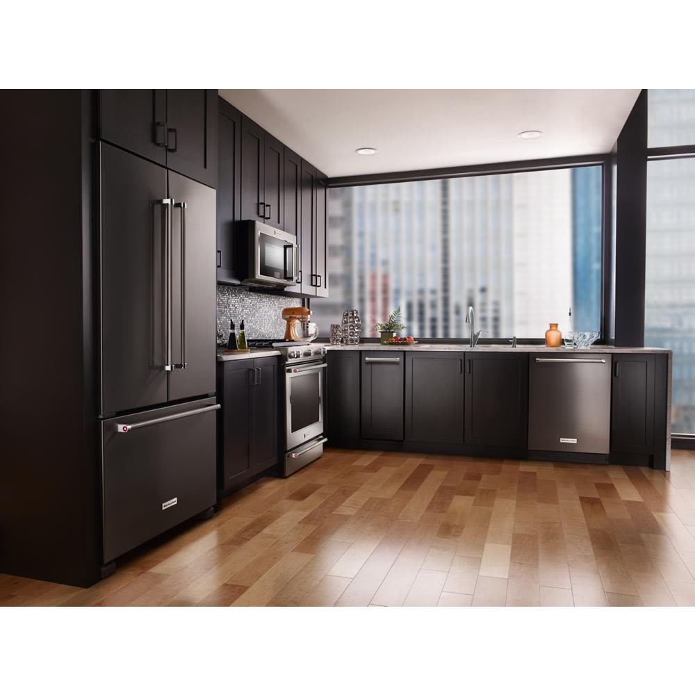 Modern kitchen with dark cabinetry, stainless steel appliances, built-in trash compactor, and city skyline view through large windows