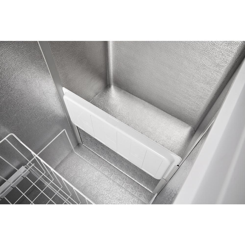 Interior of a convertible chest freezer showing metal walls, storage basket, and a white divider panel from Freezers collection