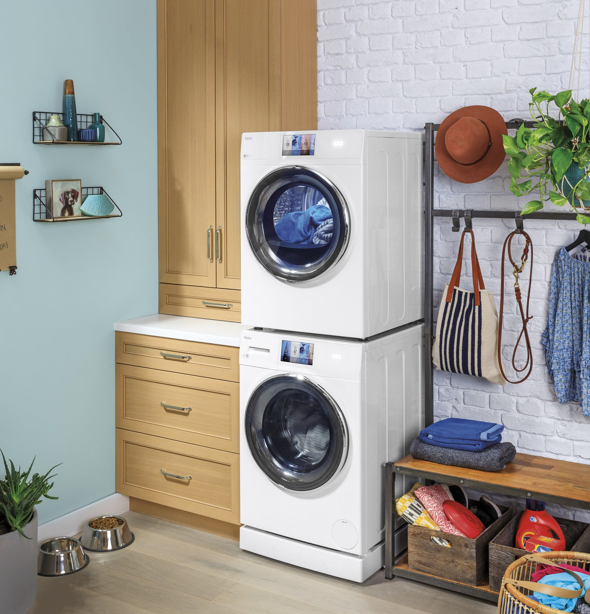 White front load washer stacked on a matching dryer with 4-inch riser in a modern laundry room setting