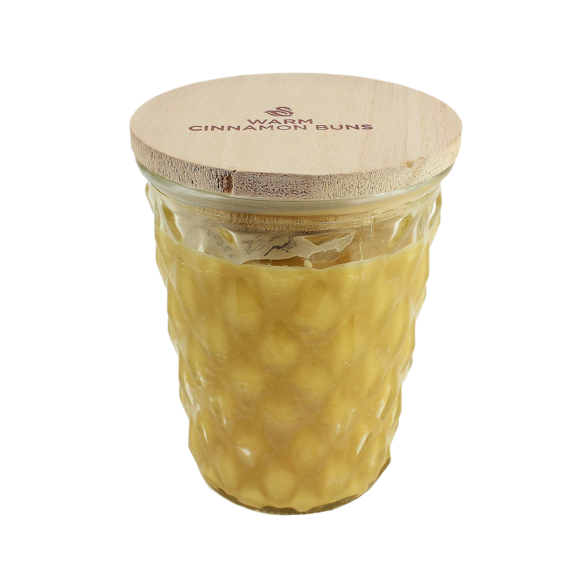 Glass jar candle with textured surface and wooden lid labeled Warm Cinnamon Buns for cozy home ambiance