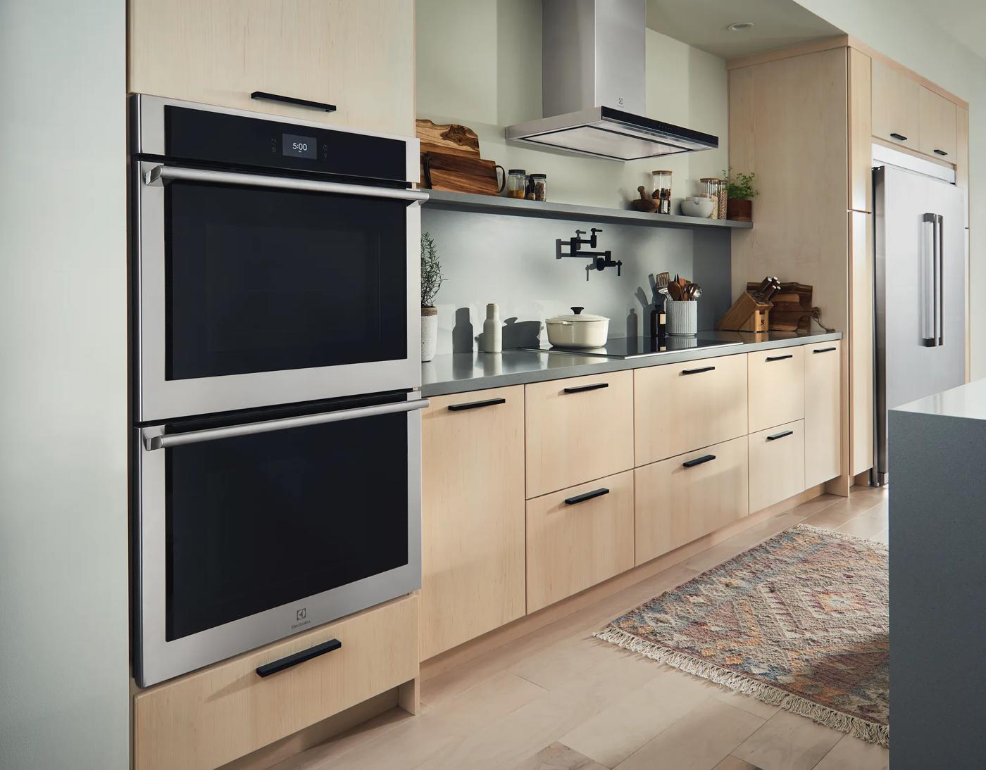 Built-in stainless steel 30-inch electric double wall oven with digital display in modern kitchen setting