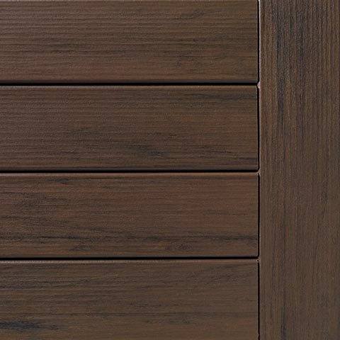 Close-up of mocha-colored decking board with hand-scraped wood texture from TimberTech’s decking and lumber materials collection