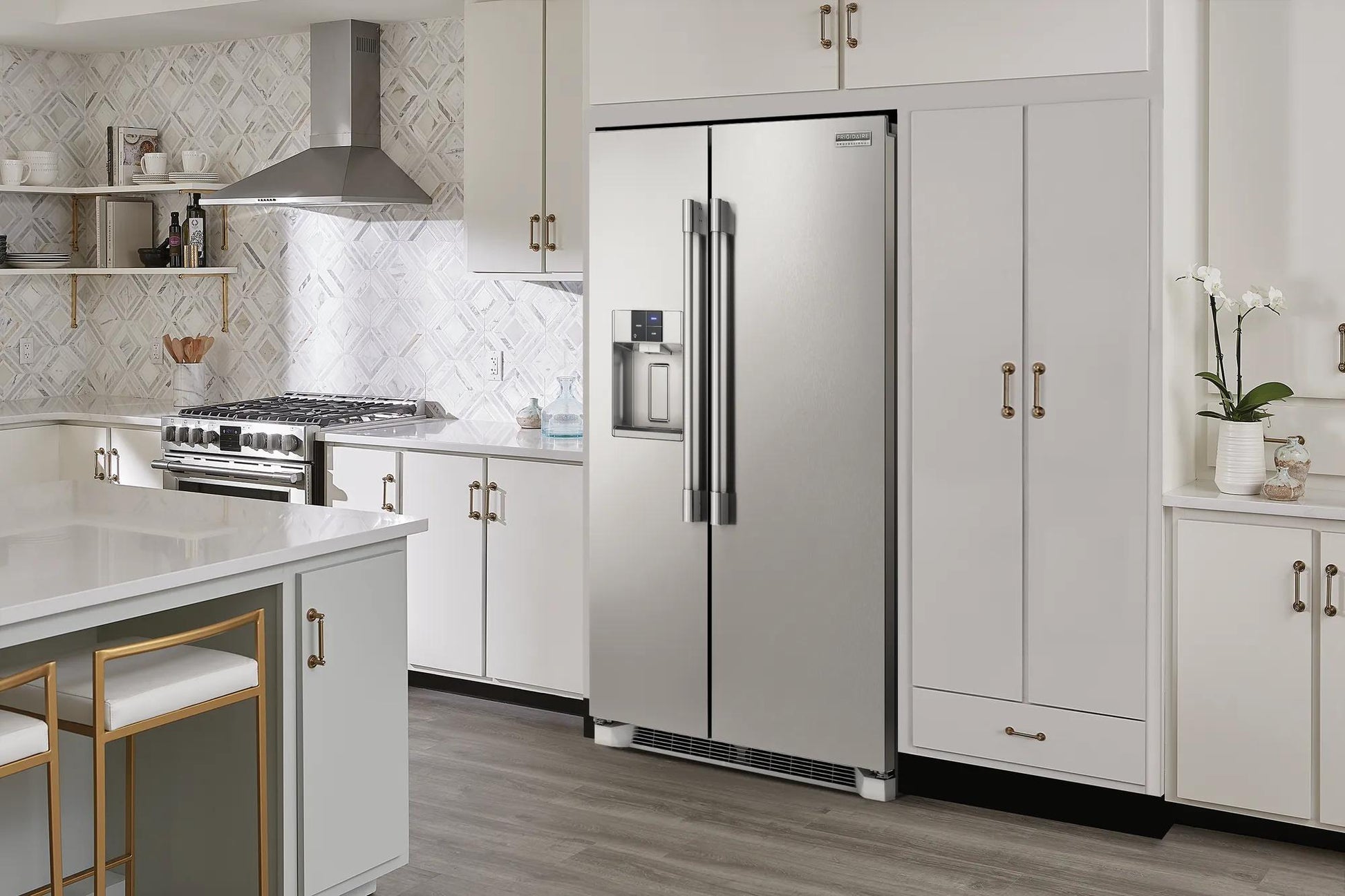 Stainless steel 22 Cu. Ft. counter-depth side-by-side refrigerator in modern kitchen with white cabinetry and appliances