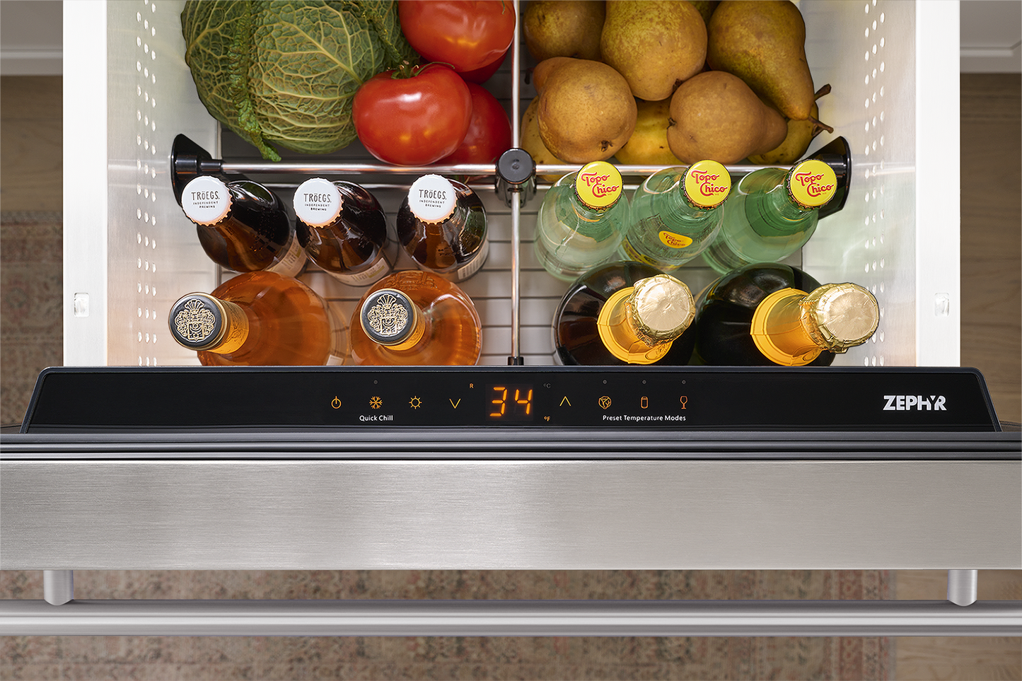 Under-counter stainless steel refrigerator drawer with digital control panel storing beverages and fresh produce
