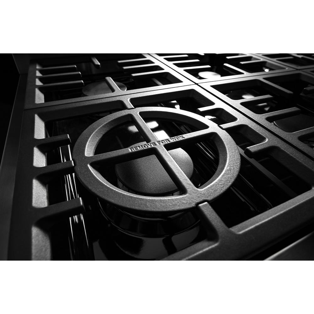 Close-up of black cast iron burner grates over gas burners on a commercial-style dual fuel kitchen range