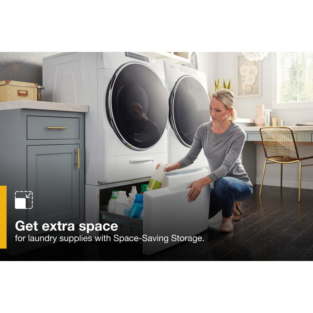 Woman placing detergent in white storage drawer pedestal beneath matching front load washer in appliance parts collection