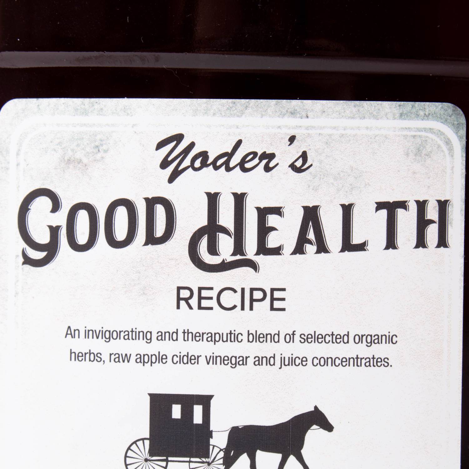 Close-up of a white label with black text describing an herbal tonic blend featuring apple cider vinegar and organic herbs