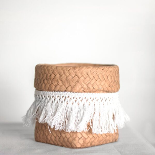 Square woven planter with white fringe detail for stylish home and garden decor applications