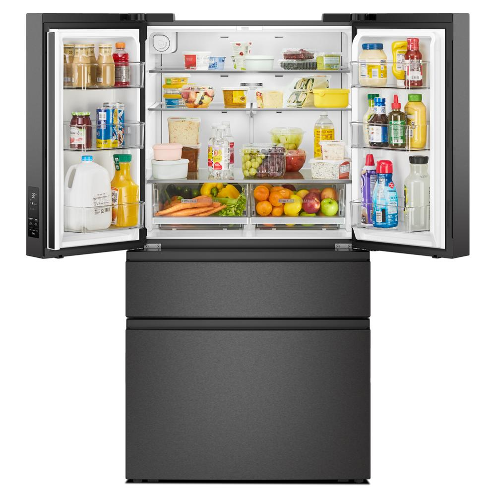 Open black French door refrigerator showing organized interior with fresh produce and beverages in kitchen appliances collection