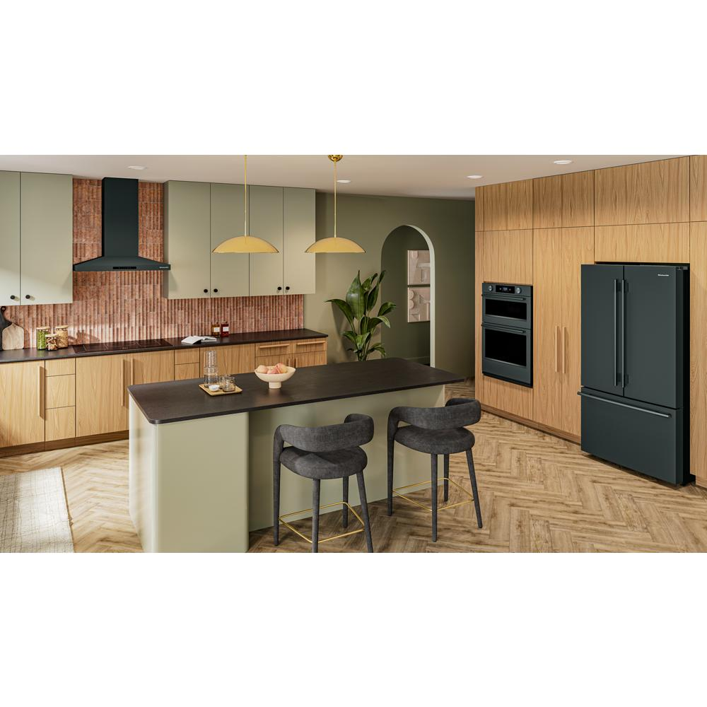 Modern kitchen with black 36-inch wall-mount canopy hood, green cabinets, wood accents, and black appliances