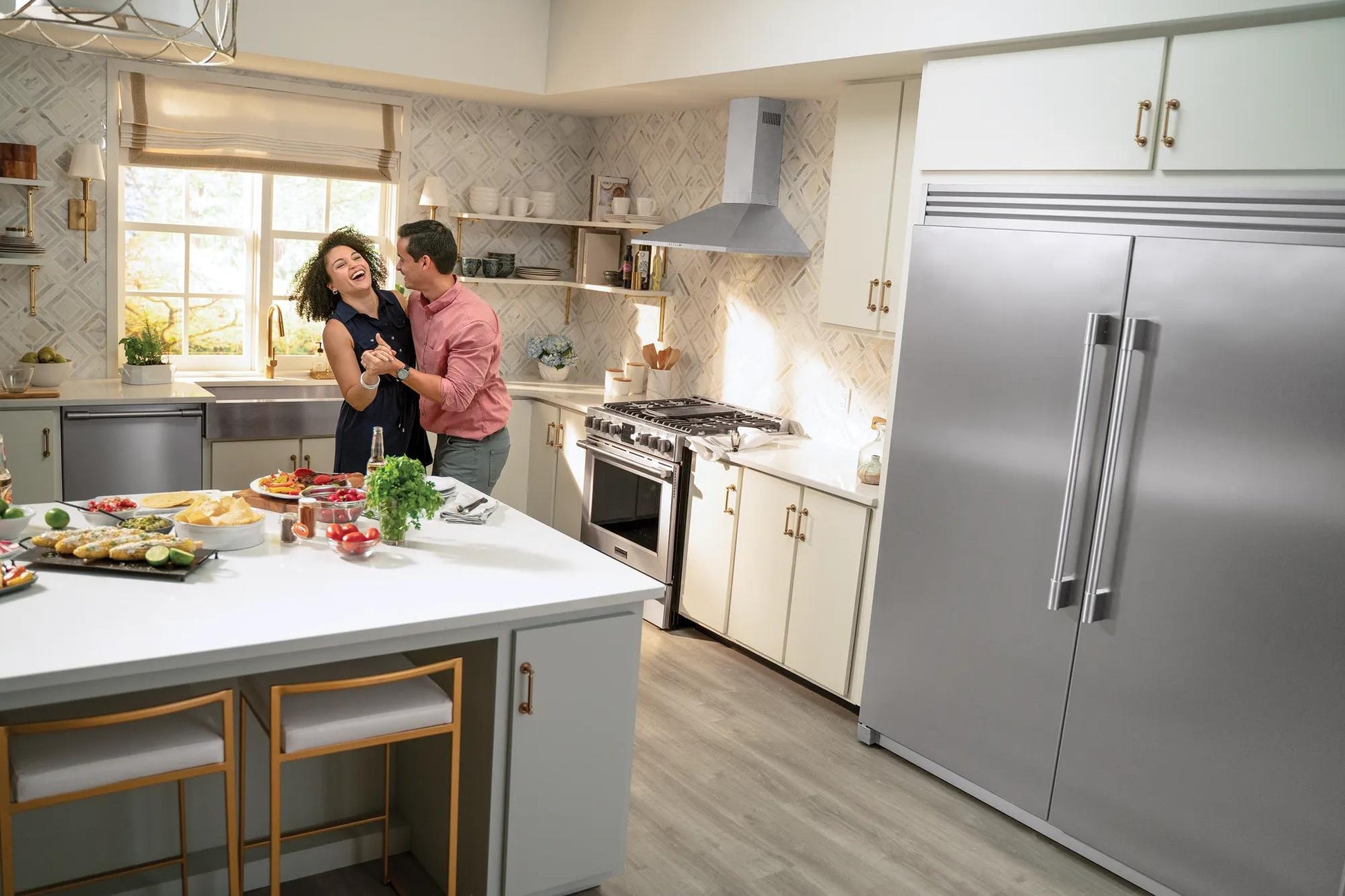 Modern kitchen featuring stainless steel single-door freezer with vertical handles and white cabinetry in home setting