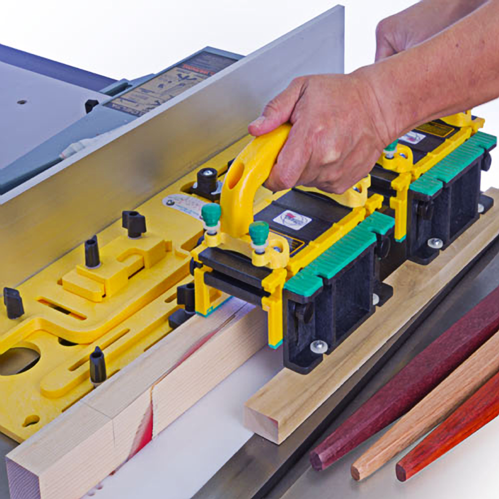 Person using a yellow Microjig Microdial tapering jig on wood piece with table saw for precise angled cuts in tool accessory setup