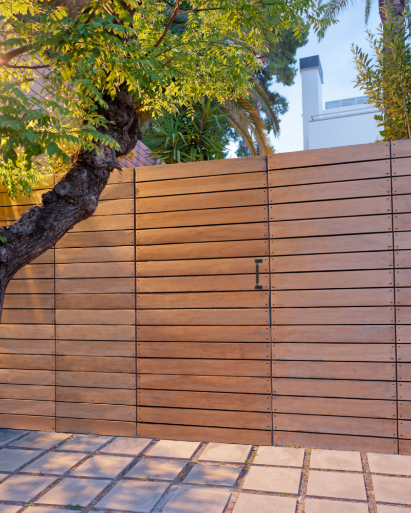 Black industrial gate pull handle mounted on a wooden modern slat gate in outdoor hardware collection under $50