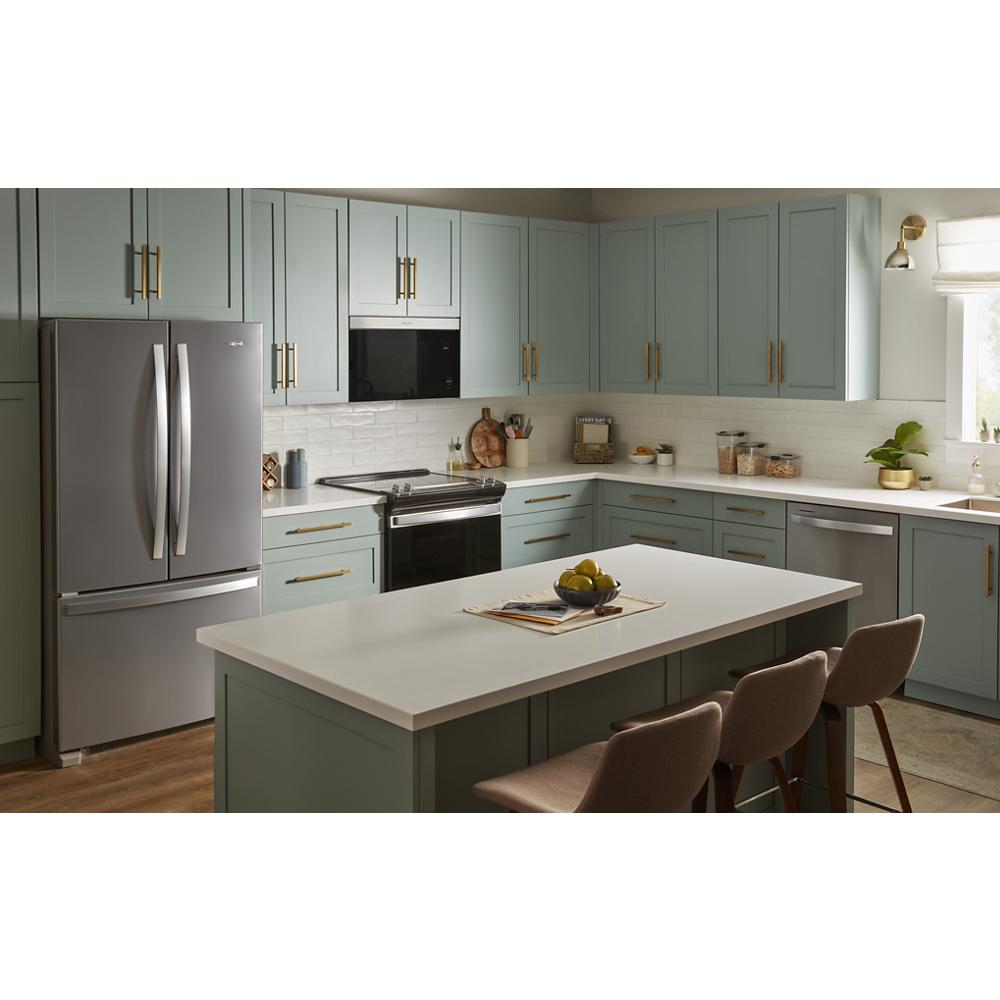 Contemporary kitchen with built-in microwave above black stove, stainless steel fridge, and blue-gray cabinetry with gold handles