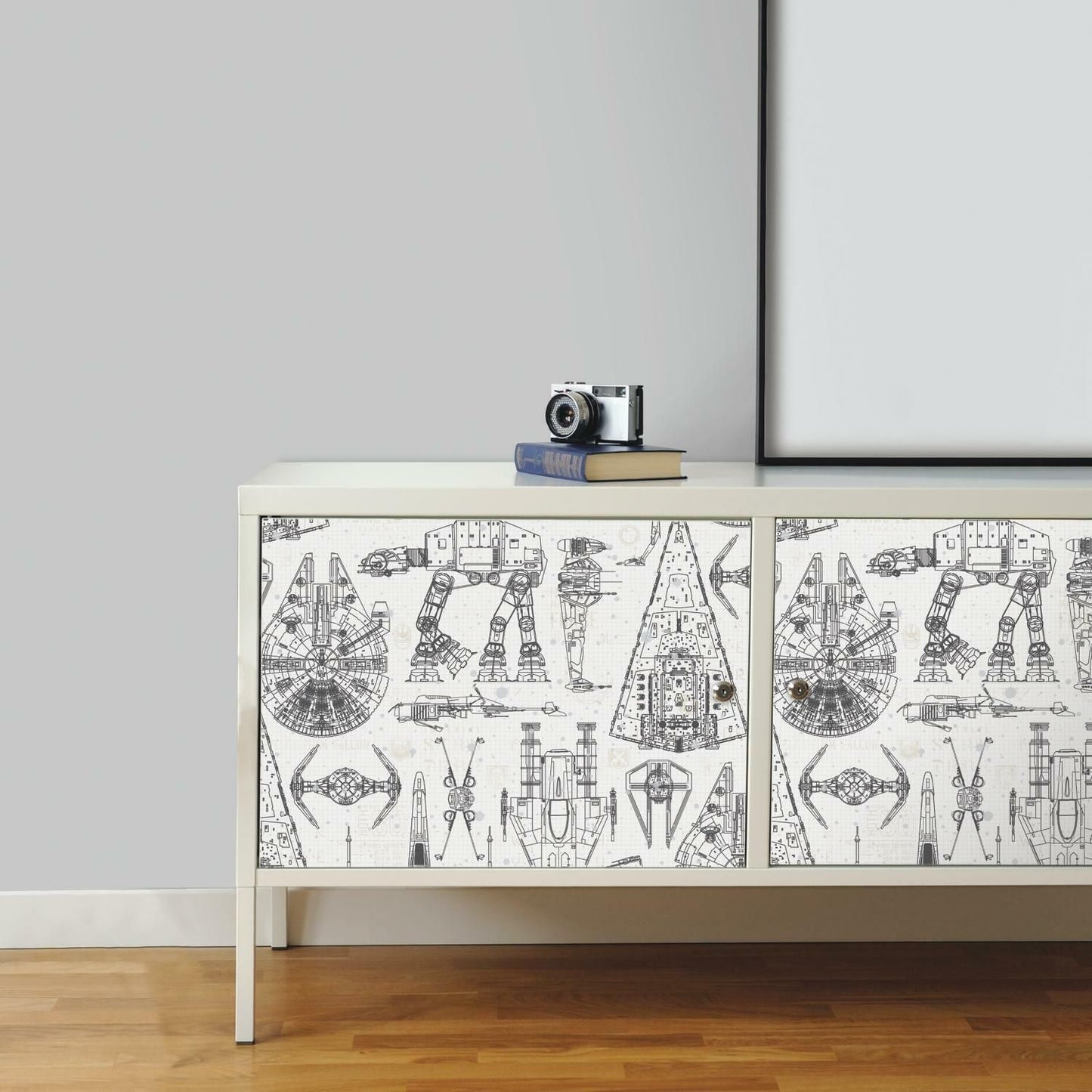 Black and white Star Wars blueprint design peel and stick wallpaper applied on cabinet front panels