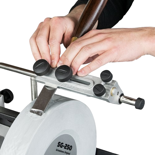Hands adjusting a sharpening jig on a grinding wheel, demonstrating precision tool use for home improvement tasks