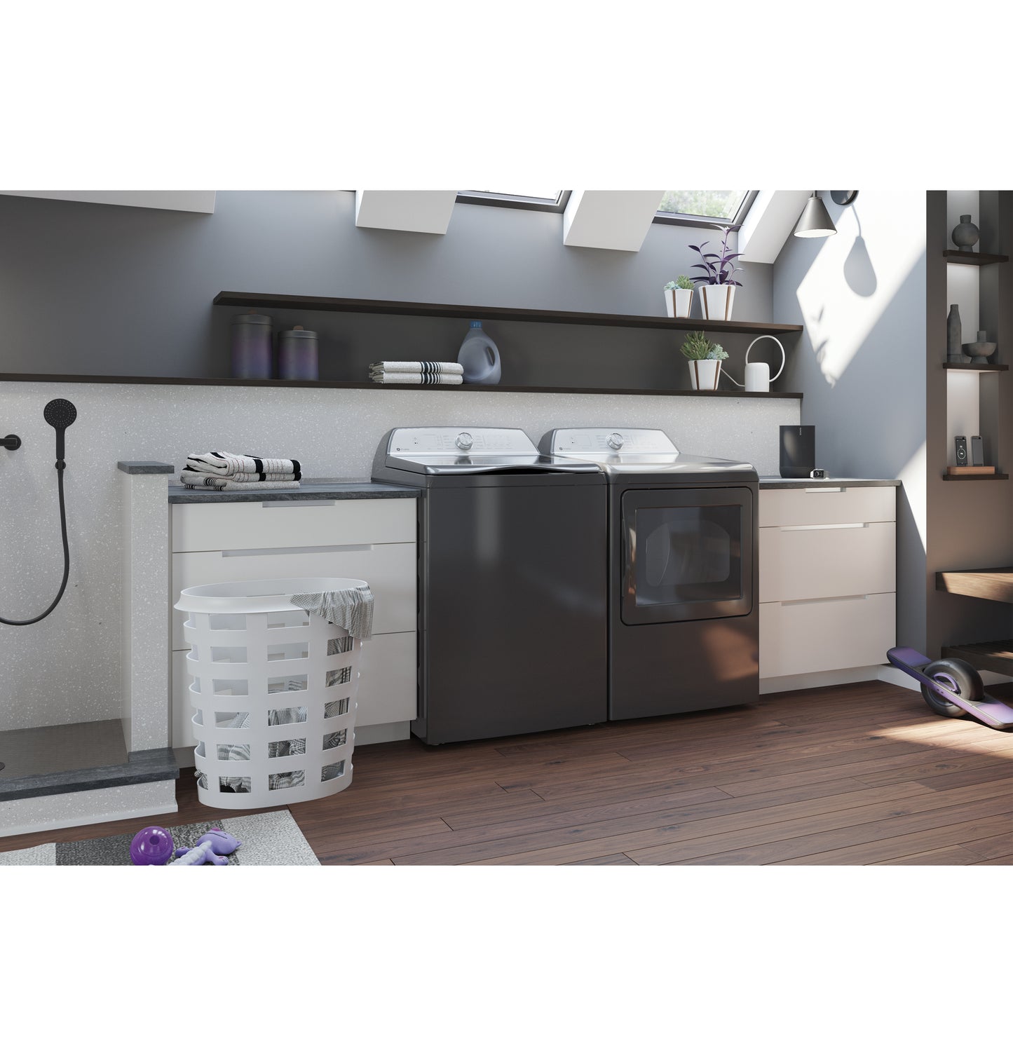 Modern laundry room with top load washer and front load dryer in dark finish surrounded by white cabinetry and hardwood floor