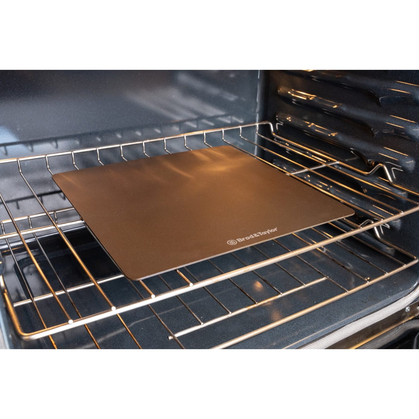 Square baking steel with smooth surface and subtle branding, designed for kitchenware and bakeware collections