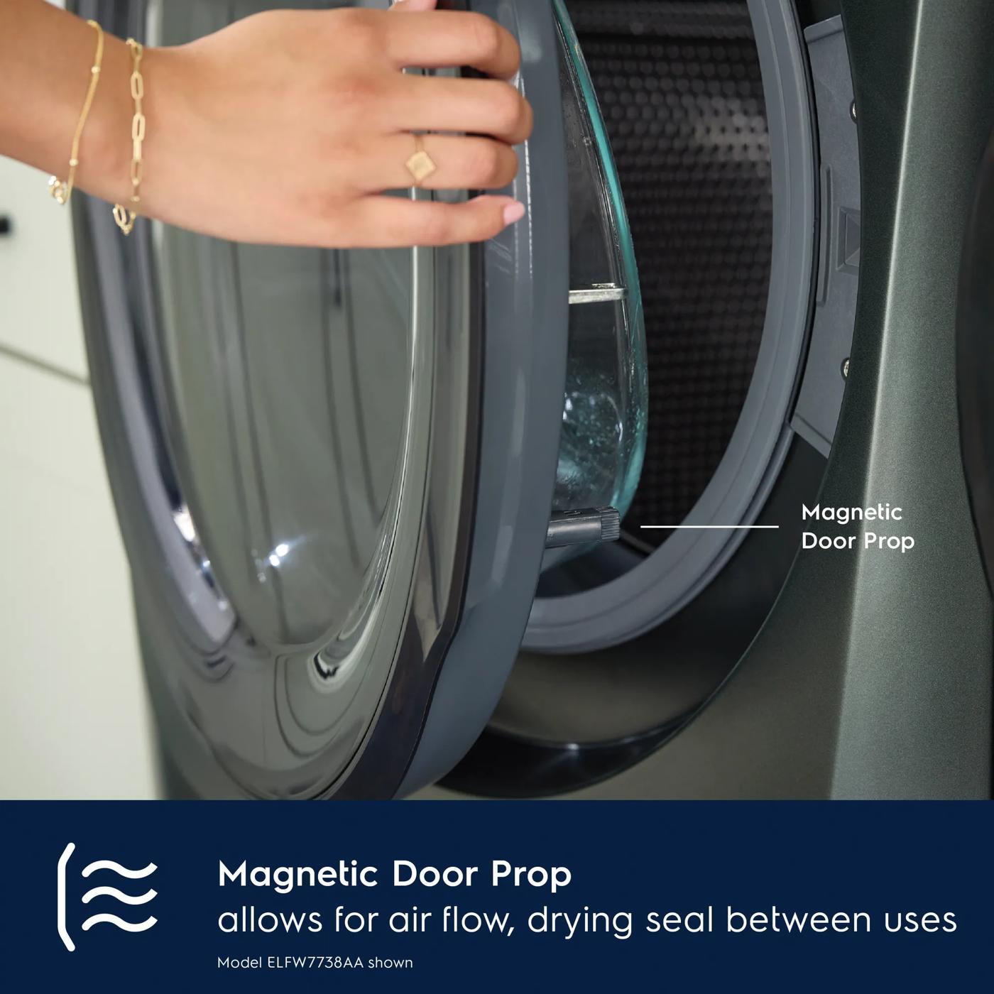 Magnetic door prop on dark gray front load washer door allowing airflow and drying seal between uses in washers collection