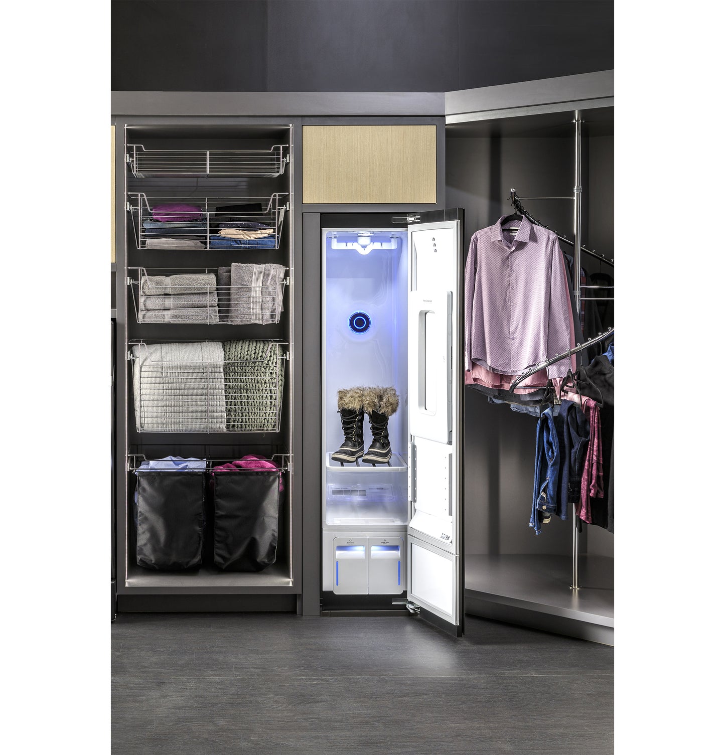 Open GE Profile steam closet with blue interior light drying winter boots in a modern appliance laundry center setting
