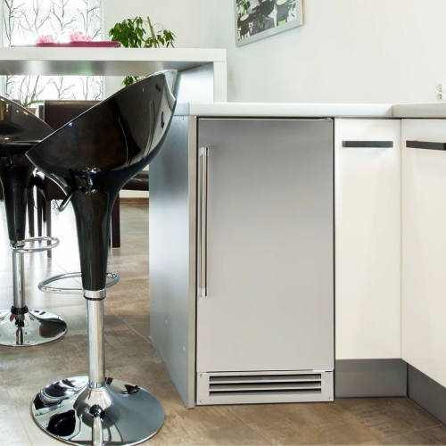 Built-in stainless steel ice maker with vertical handle and vented base in modern kitchen setting from appliances collection