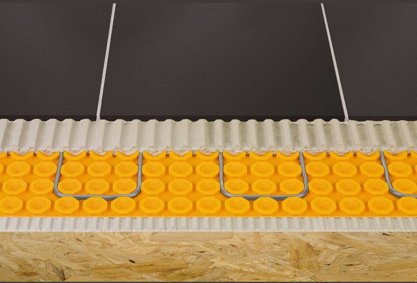 Cross-section of electric floor heating cables secured in yellow uncoupling membrane for tile flooring and home improvement tools