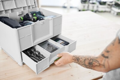 Compact white modular tool storage with pull-out drawers organizing drill bits and woodworking accessories for workshop use