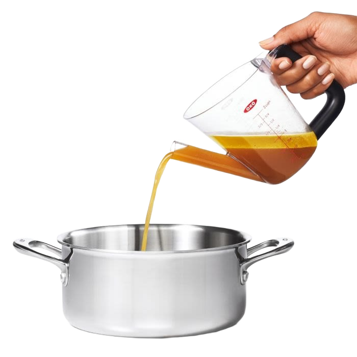 Clear fat separator with black handle pouring liquid into stainless steel pot for kitchenware and gadgets collections
