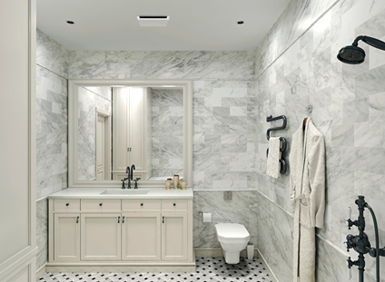 Bright bathroom with marble walls, black fixtures, wall-mounted towel rack, and vanity with mirror for home improvement use