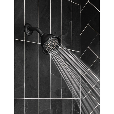 Matte black showerhead spraying water, mounted on dark tiled wall, for bathroom and home improvement use