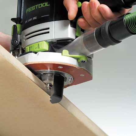 Close-up of a Festool handheld router trimming a wooden board for precise home improvement woodworking tasks