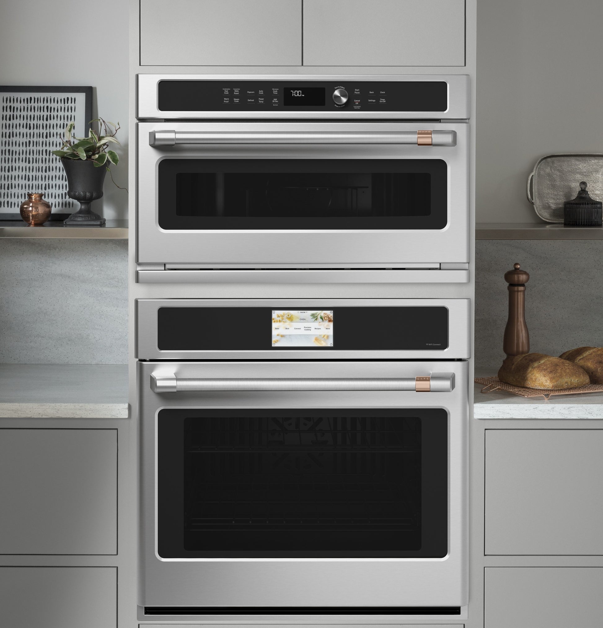 Built-in smart stainless steel wall ovens with convection and digital controls in a modern kitchen setting