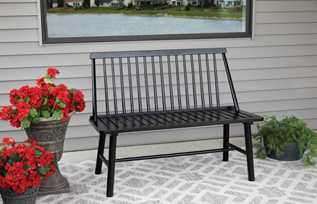 Outdoor black hardwood bench with vertical slat backrest on patterned patio for garden and outdoor living decor