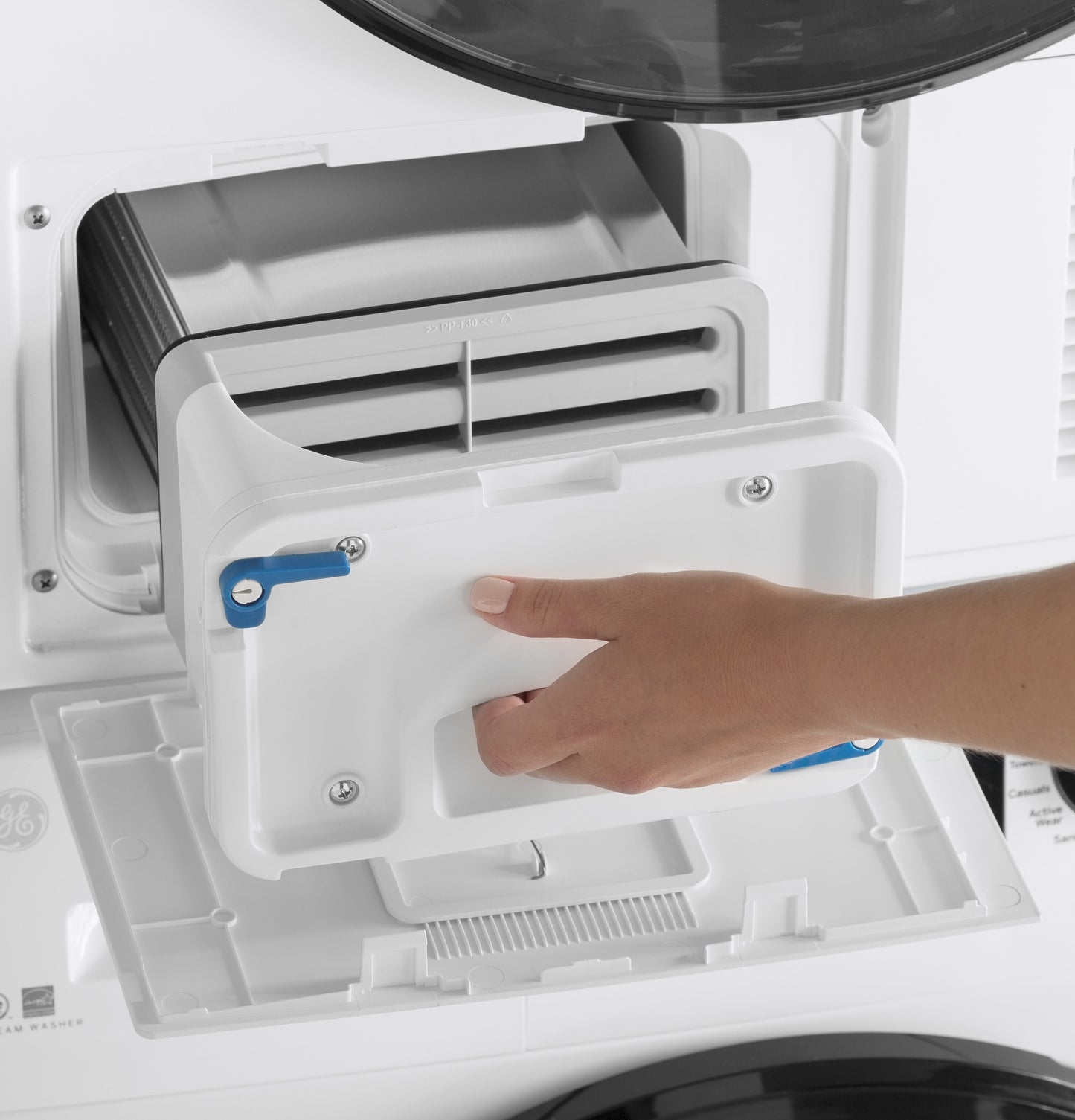 Hand removing lint filter from front load ventless condenser electric dryer in appliances and electric dryers collection