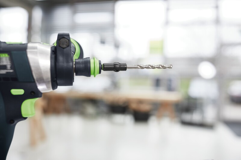 Power drill with metal spiral drill bit attached for precision drilling in tool and home improvement projects