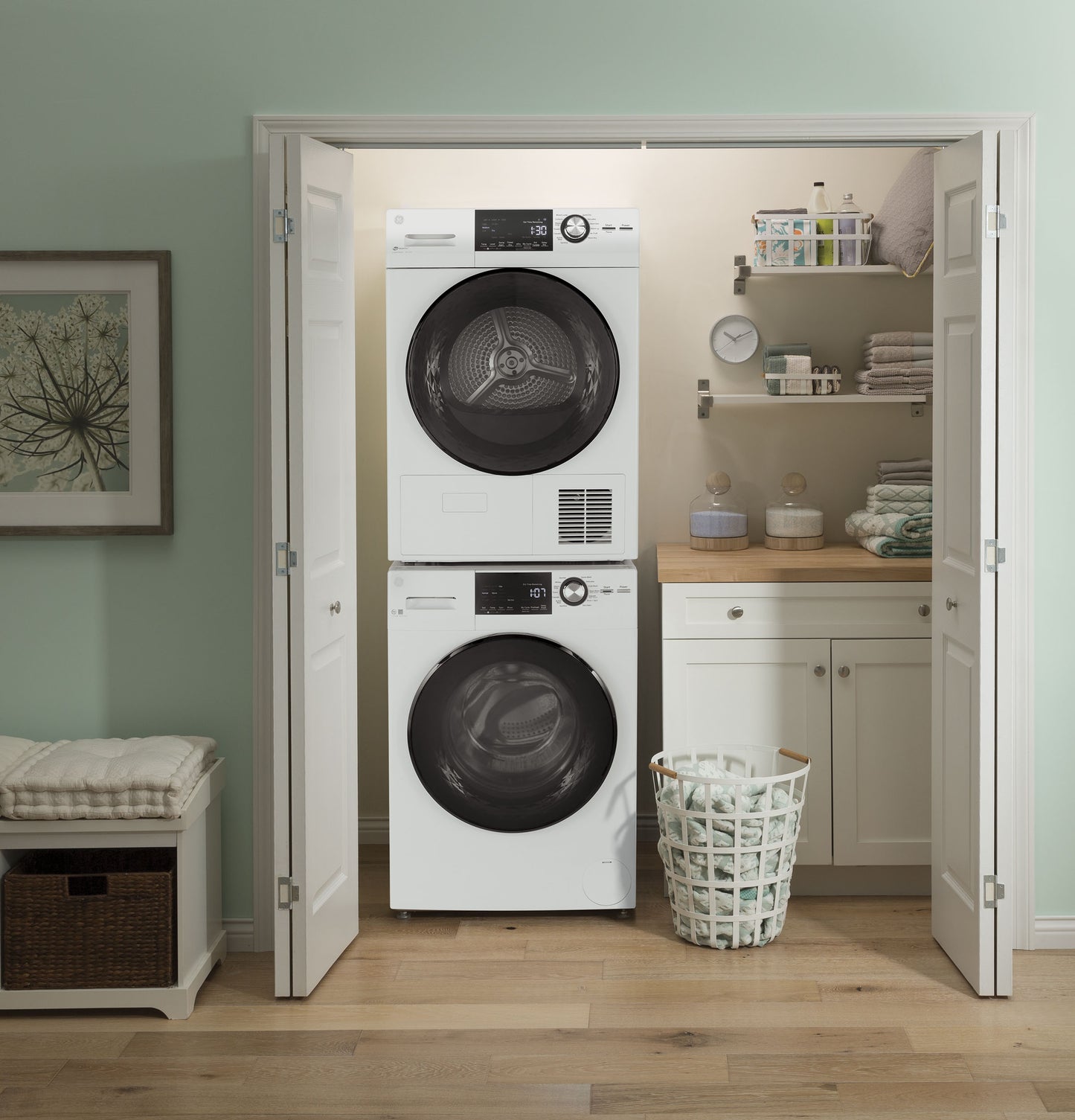 White stacked front load washer and dryer set in a bright laundry nook from washers and dryers collection